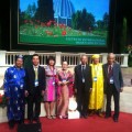 Delegates gathered in front of stage in colourful costumes